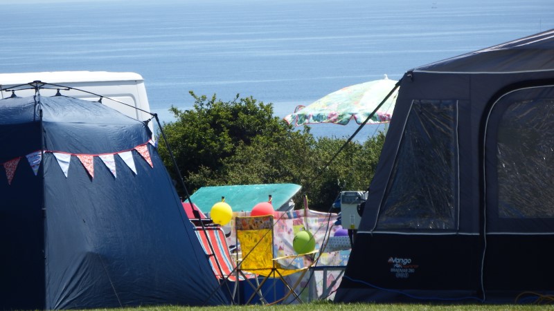 Tents and bunting with the sea beyond